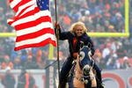 DENVER - JANUARY 03:  Ann Judge-Wegener carries the Stars and Stripes as she rides Thunder across the playing field after the Denver Broncos scored against the Kansas City Chiefs during NFL action at Invesco Field at Mile High on January 3, 2010 in Denver, Colorado. The Chiefs defeated the Broncos 44-24.  (Photo by Doug Pensinger/Getty Images)