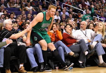 PHOENIX - DECEMBER 30:  Brian Scalabrine #44 of the Boston Celtics falls into the crowd during the NBA game against the Phoenix Suns at US Airways Center on December 30, 2009 in Phoenix, Arizona. The Suns defeated the Celtics 116-98.  NOTE TO USER: User expressly acknowledges and agrees that, by downloading and or using this photograph, User is consenting to the terms and conditions of the Getty Images License Agreement.  (Photo by Christian Petersen/Getty Images)