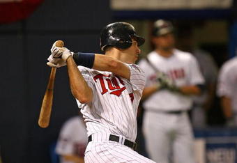 MINNEAPOLIS - OCTOBER 11: Joe Mauer #7 of the Minnesota Twins hits a run-scoring single in the 6th inning against the New York Yankees in Game Three of the ALDS during the 2009 MLB Playoffs at the Hubert H. Humphrey Metrodome on October 11, 2009 in Minneapolis, Minnesota. (Photo by Jonathan Daniel/Getty Images)