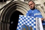 LONDON, ENGLAND - FEBRUARY 10:  Portsmouth football club fan David Maples waves a club flag outside the High Court on February 10, 2010 in London, England. Portsmouth FC have seven days to provide a 'statement of financial affairs' proving they can pay their creditors to avoid a winding-up petition.  (Photo by Oli Scarff/Getty Images)