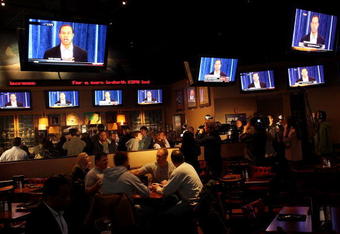NEW YORK - FEBRUARY 19:  People watch television monitors as professional golfer Tiger Woods makes his first public statement concerning a string of infidelities he has confessed to February 19, 2010 at an ESPN restaurant in Times Square in New York City. Woods, who made the highly anticipated comments at a tightly controlled event from PGA Tour headquarters in Ponte Vedra Beach, Florida, apologized to his family, friends and fans and said that he will return to sexual addiction rehab Saturday and that he could return to golf as early as this year.  (Photo by Spencer Platt/Getty Images)