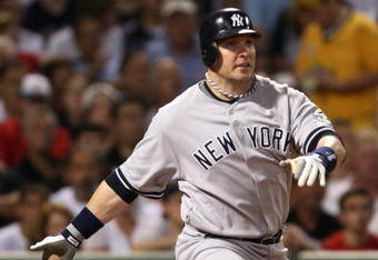 BOSTON - AUGUST 21:  Eric Hinske #14 of the New York Yankees knocks in a run in the second inning against the Boston Red Sox at Fenway Park on August 21, 2009 in Boston, Massachusetts. (Photo by Jim Rogash/Getty Images)