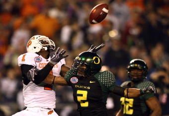 SAN DIEGO, CA - DECEMBER 30:   Wide Receiver Dez Bryant  #1 of the Oklahoma State University Cowboys jumps up to catch the ball as Free Safety T.J. Ward #2 of the University of Oregon Ducks breaks up the pass during the Pacific Life Holiday Bowl at Qualcomm Stadium on December 30, 2008 in San Diego, California. (Photo by Donald Miralle/Getty Images)