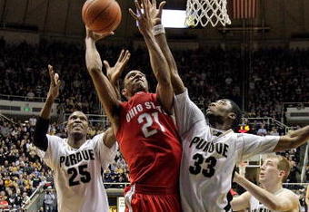 WEST LAFAYETTE, IN - JANUARY 12: Evan Turner #21  of the Ohio State Buckeyes shoots the ball while defended by JaJuan Johnson #25 and E'Twaun Moore #33 of the Purdue Boilermakers  during the Big Ten game at Mackey Arena on January 12, 2010 in West Lafayette, Indiana. Ohio state won 70-66.  (Photo by Andy Lyons/Getty Images)