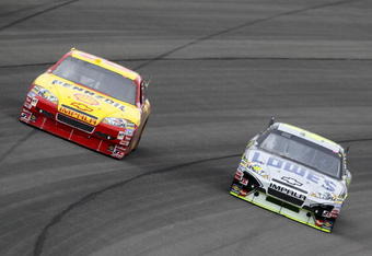 FONTANA, CA - FEBRUARY 21:  Kevin Harvick, driver of the #29 Shell Pennzoil Chevrolet, takes a turn alongside Jimmie Johnson, driver of the #48 Lowe's/Kobalt Tools Chevrolet, during the NASCAR Sprint Cup Series Auto Club 500 at Auto Club Speedway on February 21, 2010 in Fontana, California.  (Photo by Jeff Gross/Getty Images)