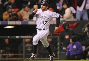 DENVER - OCTOBER 11:  Todd Helton #17 of the Colorado Rockies heads home as he scores on a RBI single in the bottom of the first inning by Garrett Atkins #27 against the Philadelphia Phillies in Game Three of the NLDS during the 2009 MLB Playoffs at Coors Field on October 11, 2009 in Denver, Colorado.  (Photo by Doug Pensinger/Getty Images)