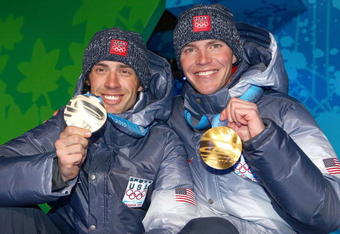 WHISTLER, BC - FEBRUARY 25:  Johnny Spillane (L) of the United States receives the silver medal and Bill Demong of the United States receives the gold medal during the medal ceremony for the men's individual large hill 10 km Nordic combined on day 14 of the Vancouver 2010 Winter Olympics at Whistler Medals Plaza on February 25, 2010 in Whistler, Canada.  (Photo by Richard Heathcote/Getty Images)