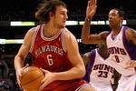 PHOENIX - JANUARY 11:  Andrew Bogut #6 of the Milwaukee Bucks handles the ball under pressure from Channing Frye #8 of the Phoenix Suns during the NBA game at US Airways Center on January 11, 2010 in Phoenix, Arizona. The Suns defeated the Rockets 118-110. NOTE TO USER: User expressly acknowledges and agrees that, by downloading and or using this photograph, User is consenting to the terms and conditions of the Getty Images License Agreement.  (Photo by Christian Petersen/Getty Images)
