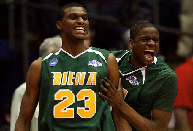 DAYTON, OH - MARCH 20:  Edwin Ubiles #23 and Clarence Jackson #13 of the Siena Saints celebrate on the court after defeating the Ohio State Buckeyes in overtime during the first round of the NCAA Division I Men's Basketball Tournament at the University of Dayton Arena on March 20, 2009 in Dayton, Ohio.  (Photo by Andy Lyons/Getty Images)