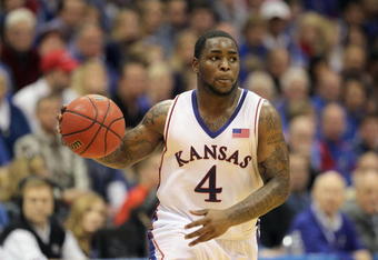 LAWRENCE, KS - FEBRUARY 06: Sherron Collins #4 of the Kansas Jayhawks dribbles the ball downcourt during the game against the Nebraska Cornhuskers on February 6, 2010 at Allen Fieldhouse in Lawrence, Kansas. (Photo by Jamie Squire/Getty Images)