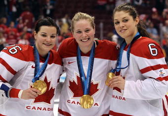 VANCOUVER, BC - FEBRUARY 25:  (L to R) Sarah Vaillancourt #26,Tessa Bonhomme #25 and Rebecca Johnston of Canada celebrate with the gold medals received following their team's 2-0 victory during the ice hockey women's gold medal game between Canada and USA on day 14 of the Vancouver 2010 Winter Olympics at Canada Hockey Place on February 25, 2010 in Vancouver, Canada.  (Photo by Bruce Bennett/Getty Images)