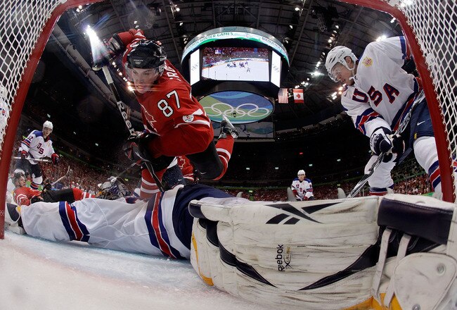 VANCOUVER, BC - FEBRUARY 21:  Sidney Crosby #87 of Canada trips over goalie Ryan Miller of the United States during the ice hockey men's preliminary game between Canada and USA on day 10 of the Vancouver 2010 Winter Olympics at Canada Hockey Place on February 21, 2010 in Vancouver, Canada. Team USa won 5-3.  (Photo by Julie Jacobson-Pool/Getty Images)