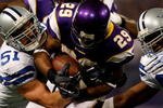 MINNEAPOLIS - JANUARY 17:  Running back Chester Taylor #29 of the Minnesota Vikings is tackled by Keith Brooking #51 of the Dallas Cowboys during the NFC Divisional Playoff Game at Hubert H. Humphrey Metrodome on January 17, 2010 in Minneapolis, Minnesota. The Vikings defeated the Cowboys 34-3. (Photo by Elsa/Getty Images)