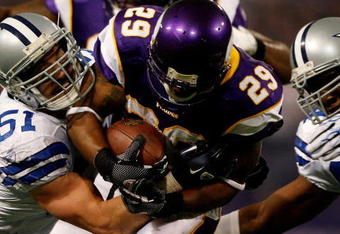 MINNEAPOLIS - JANUARY 17:  Running back Chester Taylor #29 of the Minnesota Vikings is tackled by Keith Brooking #51 of the Dallas Cowboys during the NFC Divisional Playoff Game at Hubert H. Humphrey Metrodome on January 17, 2010 in Minneapolis, Minnesota. The Vikings defeated the Cowboys 34-3. (Photo by Elsa/Getty Images)
