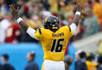 JACKSONVILLE, FL - JANUARY 01:  Quarterback Jarrett Brown #16 of the West Virginia Mountaineers celebrates a long first down run against the Florida State Seminoles during the Konica Minolta Gator Bowl on January 1, 2010 in Jacksonville, Florida.  (Photo by Doug Benc/Getty Images)