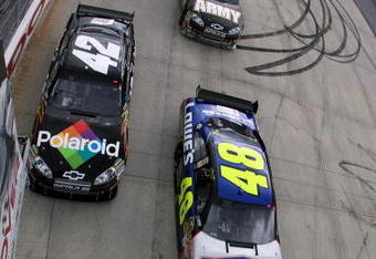 DOVER, DE - SEPTEMBER 27:  Jimmie Johnson (R), driver of the #48 Lowe's Chevrolet and Juan Pablo Montoya, driver of the #42 Polaroid Chevrolet lead the field at the start of the NASCAR Sprint Cup Series AAA 400 at Dover International Speedway on September 27, 2009 in Dover, Delaware.  (Photo by Chris Trotman/Getty Images)