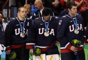 VANCOUVER, BC - FEBRUARY 28:  Dejected Team USA players look on after receiving the silver medal won during the ice hockey men's gold medal game between USA and Canada on day 17 of the Vancouver 2010 Winter Olympics at Canada Hockey Place on February 28, 2010 in Vancouver, Canada.  (Photo by Bruce Bennett/Getty Images)