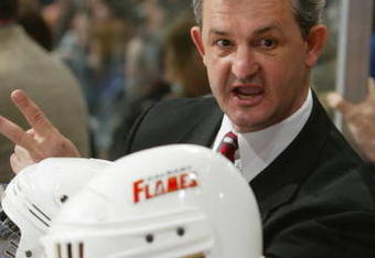 VANCOUVER - APRIL 15:  Head Coach Darryl Sutter of the Calgary Flames instructs his players during game five against the Vancouver Canucks in the first round of the 2004 Stanley Cup Playoffs at General Motors Place on April 15, 2004 in Vancouver, Canada. The Flames defeated the Canucks 2-1 to take a 3-2 lead in the series. (Photo by Jeff Vinnick/Getty Images)
