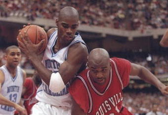 23 Mar 1997:  Guard Antawn Jamison of the North Carolina Tarheels holds the ball as forward Nate Johnson of the Louisville Cardinals falls over him during a playoff game at the Carrier Dome in Syracuse, New York.  The Tarheels won the game 97 - 74. Mandat