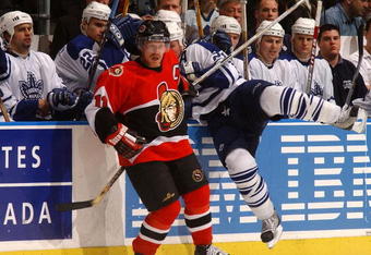 TORONTO, CAN - MAY 10: Daniel Alfredsson #11 of the Ottawa Senators checks Bryan McCabe #24 of the Toronto Maple Leafs during game five of the Eastern Conference Semi Finals at the Air Canada Centre, Toronto, Canada on May, 10, 2002. The Senators won the game 4-2.  (Photo by Dave Sandford/Getty Images/NHLI)  