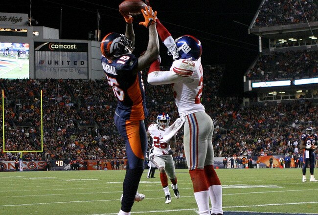 DENVER - NOVEMBER 26:  Corey Webster #23 of the New York Giants breaks up a pass in the endzone intended for wide receiver Brandon Marshall #15 of the Denver Broncos during NFL action at Invesco Field at Mile High on November 26, 2009 in Denver, Colorado. The Broncos defeated the Giants 26-6.  (Photo by Doug Pensinger/Getty Images)