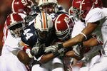 AUBURN, AL - NOVEMBER 24:  Running back Ben Tate #44 of the Auburn Tigers drags a group of Alabama Crimson Tide defenders at Jordan-Hare Stadium on November 24, 2007 in Auburn, Alabama.   (Photo by Doug Benc/Getty Images)