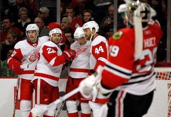 CHICAGO - MARCH 07: (L-R) Drew Miller #20, Brett Lebda #22, Valtteri Filppula #51 and Todd Bertuzzi #44 of the Detroit Red Wings celebrate a second period goal against Cristobal Huet #39 of the Chicago Blackhawks at the United Center on March 7, 2010 in Chicago, Illinois. (Photo by Jonathan Daniel/Getty Images)