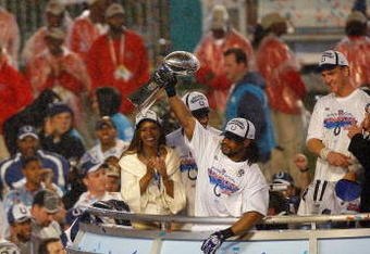 MIAMI GARDENS, FL - FEBRUARY 04:  Bob Sanders #21 of  the Indianapolis Colts celebrates with the Vince Lombardi Trophy, next to head coach Tony Dungy and his wife Lauren Dungy, after the Colts 29-17 win against the Chicago Bears in Super Bowl XLI on February 4, 2007 at Dolphin Stadium in Miami Gardens, Florida.  (Photo by Eliot J. Schechter/Getty Images)