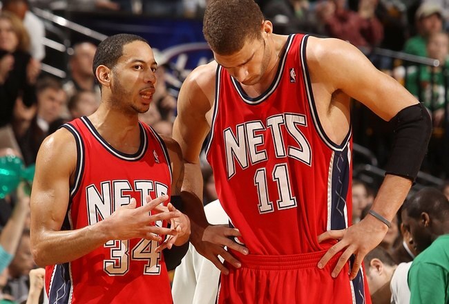 BOSTON - FEBRUARY 27:  Devin Harris #34 of the New Jersey Nets talks with Brook Lopez #11 during a time out against the Boston Celtics at the TD Garden on February 27, 2010 in Boston, Massachusetts. The Nets defeated the Celtics 104-96.  NOTE TO USER: User expressly acknowledges and agrees that, by downloading and or using this photograph, User is consenting to the terms and conditions of the Getty Images License Agreement.  (Photo by Elsa/Getty Images)