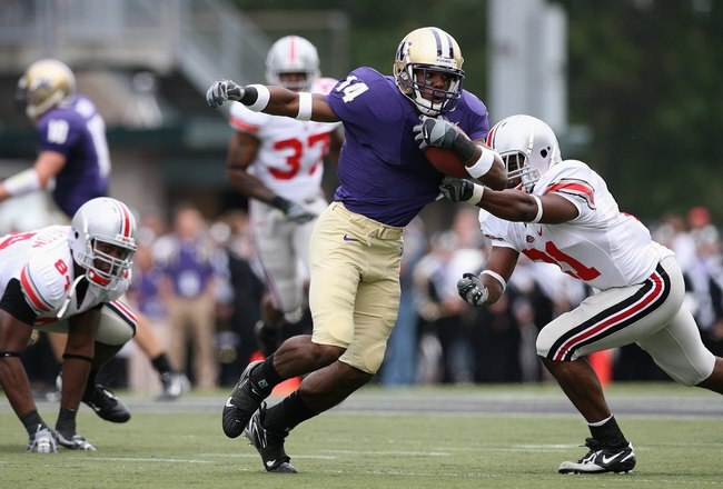 SEATTLE - SEPTEMBER 15:  Curtis Shaw #14 of the Washington Huskies carries the ball against Anderson Russell #21 of the Ohio State Buckeyes at Husky Stadium on September 15, 2007 in Seattle, Washington. Ohio State won 33-14. (Photo by Otto Greule Jr/Getty Images)