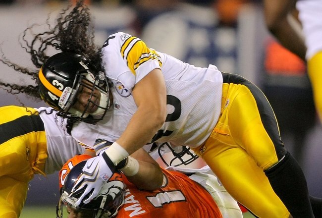 DENVER - NOVEMBER 09:  Brandon Marshall #15 of the Denver Broncos makes a reception and it stopped by Troy Polamalu #43 of the Pittsburgh Steelers on during NFL action at Invesco Field at Mile High on November 9, 2009 in Denver, Colorado. The Steelers defeated the Broncos 28-10.  (Photo by Doug Pensinger/Getty Images)