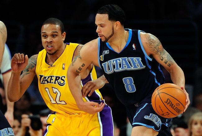 LOS ANGELES, CA - APRIL 21:  Deron Williams #8 of the Utah Jazz drives on Shannon Brown #12 of the Los Angeles Lakers in the first half of Game Two of the Western Conference Quarterfinals during the 2009 NBA Playoffs at Staples Center on April 21, 2009 in Los Angeles, California. NOTE TO USER: User expressly acknowledges and agrees that, by downloading and or using this photograph, User is consenting to the terms and conditions of the Getty Images License Agreement.  (Photo by Kevork Djansezian/Getty Images)