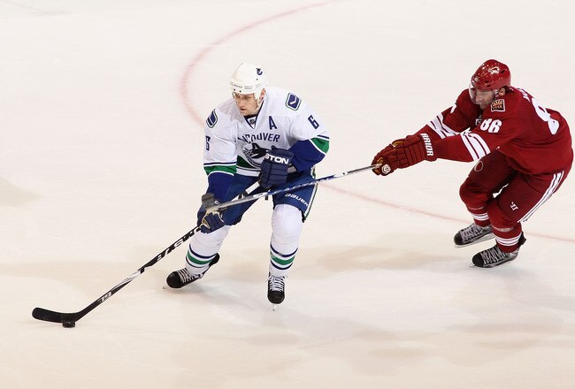 GLENDALE, AZ - MARCH 10:  Sami Salo #6 of the Vancouver Canucks skates with the puck past Wojtek Wolski #86 of the Phoenix Coyotes during the NHL game at Jobing.com Arena on March 10, 2010 in Glendale, Arizona. The Coyotes defeated the Canucks 4-3 in an overtime shootout.  (Photo by Christian Petersen/Getty Images)
