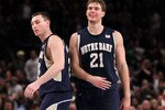 NEW YORK - MARCH 11: Ben Hansbrough #23 and Tim Abromaitis #21 of the Notre Dame Fighting Irish react after defeating the Pittsburgh Panthers during the quarterfinal of the 2010 NCAA Big East Tournament at Madison Square Garden on March 11, 2010 in New York City.  (Photo by Jim McIsaac/Getty Images)