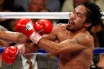 LAS VEGAS - NOVEMBER 14:  (L-R) Miguel Cotto of Puerto Rico throws a left to the head of Manny Pacquiao during their WBO welterweight title fight at the MGM Grand Garden Arena on November 14, 2009 in Las Vegas, Nevada. Pacquiao defeated Cotto by 12th round TKO.  (Photo by Ethan Miller/Getty Images)