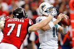 ATLANTA - SEPTEMBER 13:  Kroy Biermann #71 of the Atlanta Falcons forces a fumble by quarterback Chad Pennington #10 of the Miami Dolphins at Georgia Dome on September 13, 2009 in Atlanta, Georgia.  (Photo by Kevin C. Cox/Getty Images)