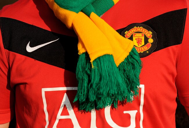 MANCHESTER, ENGLAND - FEBRUARY 06: A Manchester United fan wears a green and yellow scarf before the Barclays Premier League match between Manchester United and Portsmouth at Old Trafford on February 6, 2010 in Manchester, England.  (Photo by Michael Regan/Getty Images)