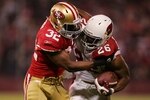 SAN FRANCISCO - DECEMBER 14:  Running back Beanie Wells #26 of the Arizona Cardinals rushes with the ball as safety Michael Lewis #32 of the San Francisco 49ers attempts to tackle him at Candlestick Park on December 14, 2009 in San Francisco, California. (Photo by Ezra Shaw/Getty Images)