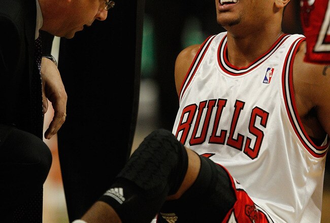 CHICAGO - MARCH 01: Trainer Fred Tedeschi of the Chicago Bulls attends to Derrick Rose #1 following a collision in the first quarter against the Atlanta Hawks at the United Center on March 1, 2010 in Chicago, Illinois. NOTE TO USER: User expressly acknowledges and agrees that, by downloading and/or using this Photograph, User is consenting to the terms and conditions of the Getty Images License Agreement. (Photo by Jonathan Daniel/Getty Images)