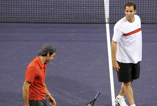 INDIAN WELLS, CA - MARCH 12:  Pete Sampras (R) of the United States tosses his racquet with Roger Federer of Switzerland in their match against Andre Agassi of the United States and Rafael Nadal of Spain during the BNP Paribas Open  Players Party & Hit for Haiti at the Indian Wells Tennis Garden on March 12, 2010 in Indian Wells, California.  (Photo by Harry How/Getty Images)