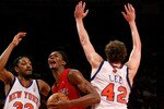 NEW YORK - JANUARY 11:  Chris Bosh #4 of the Toronto Raptors drives through David Lee #42  and Renaldo Balkman #32 of the New York Knicks on January 11, 2008 at Madison Square Garden in New York City. NOTE TO USER: User expressly acknowledges and agrees that, by downloading and/or using this Photograph, User is consenting to the terms and conditions of the Getty Images License Agreement.  (Photo by Nick Laham/Getty Images)