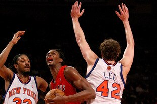 NEW YORK - JANUARY 11:  Chris Bosh #4 of the Toronto Raptors drives through David Lee #42  and Renaldo Balkman #32 of the New York Knicks on January 11, 2008 at Madison Square Garden in New York City. NOTE TO USER: User expressly acknowledges and agrees that, by downloading and/or using this Photograph, User is consenting to the terms and conditions of the Getty Images License Agreement.  (Photo by Nick Laham/Getty Images)