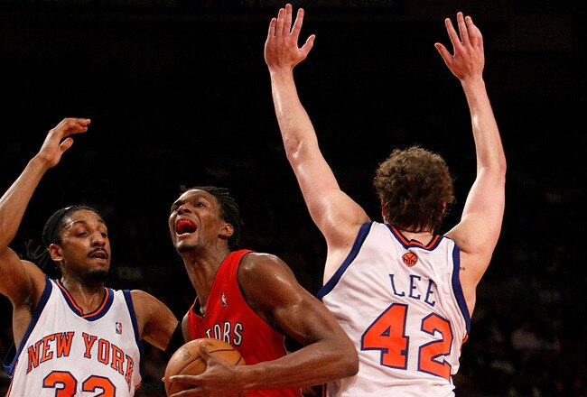 NEW YORK - JANUARY 11:  Chris Bosh #4 of the Toronto Raptors drives through David Lee #42  and Renaldo Balkman #32 of the New York Knicks on January 11, 2008 at Madison Square Garden in New York City. NOTE TO USER: User expressly acknowledges and agrees that, by downloading and/or using this Photograph, User is consenting to the terms and conditions of the Getty Images License Agreement.  (Photo by Nick Laham/Getty Images)