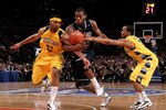 NEW YORK - MARCH 12: Greg Monroe #10 of the Georgetown Hoyas drives through Lazar Hayward #32 and Maurice Acker #2 of the Marquette Golden Eagles during the semifinal of the 2010 Big East Tournament at Madison Square Garden on March 12, 2010 in New York City.  (Photo by Jim McIsaac/Getty Images)
