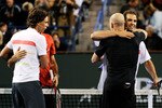 INDIAN WELLS, CA - MARCH 12: Former tennis player  Andre Agassi (L) hugs Pete Sampras as Rafael Nadal of Spain, and Roger Federer of Switzerland, look on at the conclusion of Hit for Haiti, a charity event during the BNP Paribas Open on March 12, 2010 in Indian Wells, California.  (Photo by Kevork Djansezian/Getty Images)