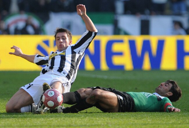 TURIN, ITALY - MARCH 14:  Zdenek Grygera of Juventus FC battles for the ball with Simone Vergassola of AC Siena during the Serie A match between Juventus FC and AC Siena at Stadio Olimpico di Torino on March 14, 2010 in Turin, Italy.  (Photo by Valerio Pennicino/Getty Images)