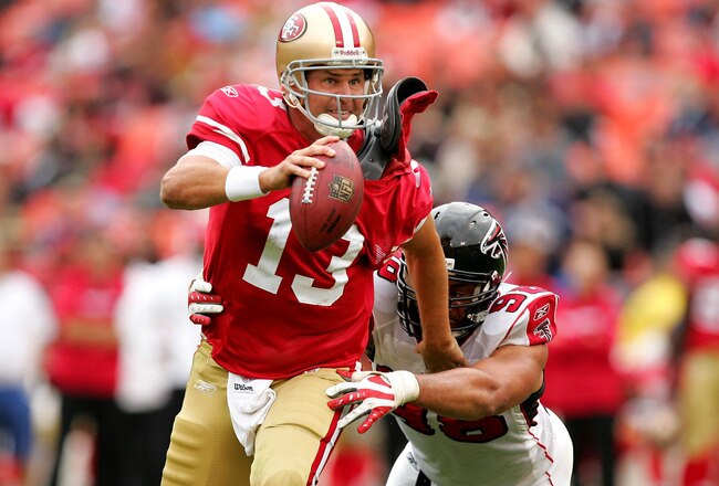 SAN FRANCISCO - OCTOBER 11:  Shaun Hill #13 of the San Francisco 49ers tries to run away from Jamaal Anderson #98 of the Atlanta Falcons at Candlestick Park on October 11, 2009 in San Francisco, California.  (Photo by Ezra Shaw/Getty Images)