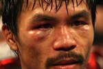 ARLINGTON, TX - MARCH 13:  Manny Pacquiao of the Philippines looks on in the ring after defeating Joshua Clottey of Ghana during the WBO welterweight title fight at Cowboys Stadium on March 13, 2010 in Arlington, Texas. Pacquiao defeated Clottey by unanimous decision.  (Photo by Jed Jacobsohn/Getty Images)