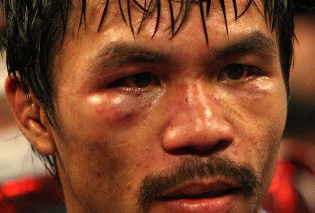 ARLINGTON, TX - MARCH 13:  Manny Pacquiao of the Philippines looks on in the ring after defeating Joshua Clottey of Ghana during the WBO welterweight title fight at Cowboys Stadium on March 13, 2010 in Arlington, Texas. Pacquiao defeated Clottey by unanimous decision.  (Photo by Jed Jacobsohn/Getty Images)