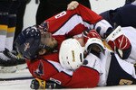 WASHINGTON - SEPTEMBER 21: Alex Ovechkin #8 of the Washington Capitals holds onto Jeff Cowan #23 of the Buffalo Sabres after a fight during an NHL preseason hockey game on September 21, 2009 at the Verizon Center in Washington, DC.. (Photo by Ned Dishman/Getty Images)